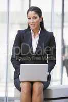 Businesswoman using laptop computer outside