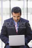 Businessman using laptop computer outside