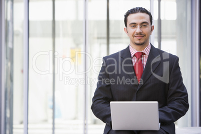 Businessman using laptop outside