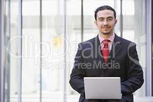 Businessman using laptop outside