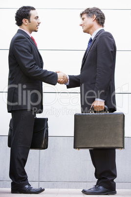 Businessmen meeting outside office