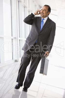 Businessman talking on mobile phone in lobby