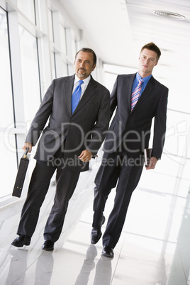 Two businessmen walking through lobby