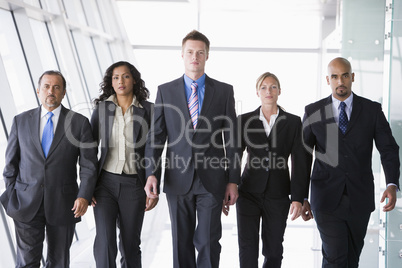 Group of business people walking towards camera