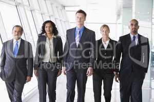 Group of business people walking towards camera
