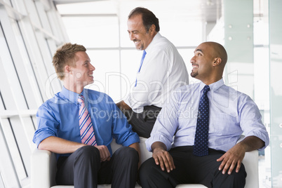Group of businessmen talking in lobby