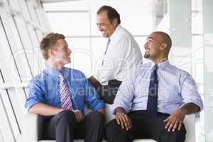 Group of businessmen talking in lobby