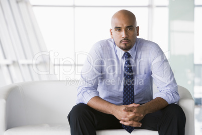 Businessman sitting on sofa in lobby