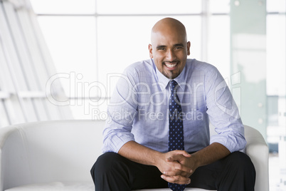 Businessman sitting on sofa in lobby