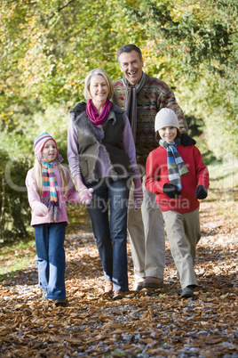 Familiy walking in the forrest in fall time