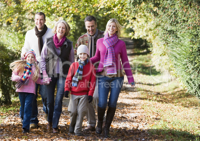 Family walking in the forrest in fall time