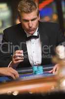 blonde man playing roulette in the casino
