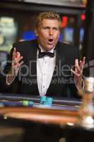 blonde man playing roulette in the casino