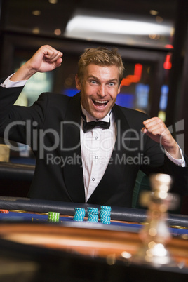 blonde man playing roulette in the casino