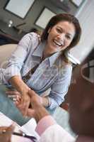 Woman shaking doctor's hand at IVF clinic