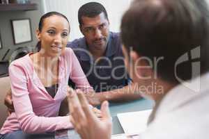 Couple having discussion with doctor in IVF clinic