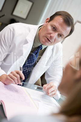 Doctor in discussion with patient in IVF clinic