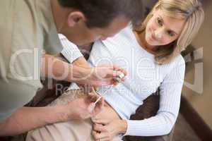 Man helping woman inject drugs to prepare for IVF treatment