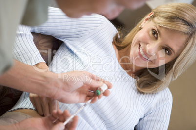 Man helping woman inject drugs to prepare for IVF treatment