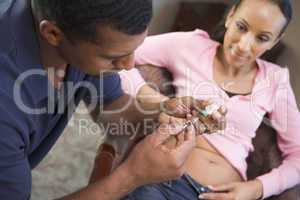 Man helping woman inject drugs to achieve pregnancy