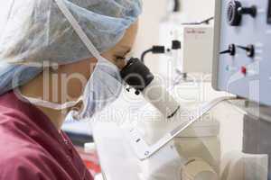 Embryologist using microscope