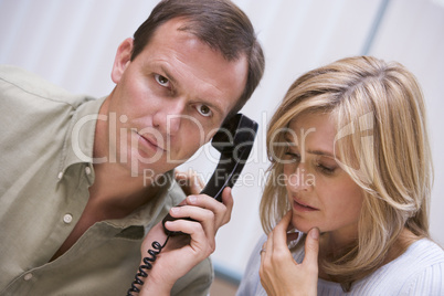 Couple receiving bad news over phone