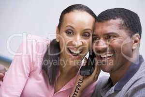 Couple receiving good news over phone