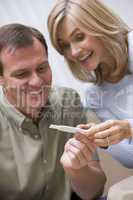 Couple looking at home pregnancy test