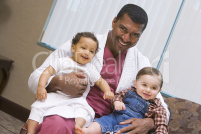 Consultant holding two IVF children