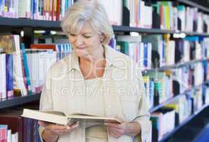 Senior woman reading in a library