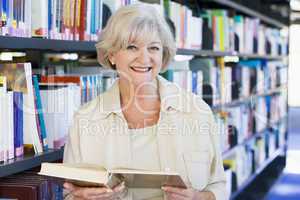 Senior woman reading in a library