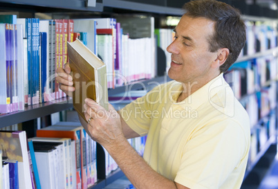 Man in a library reading book cover