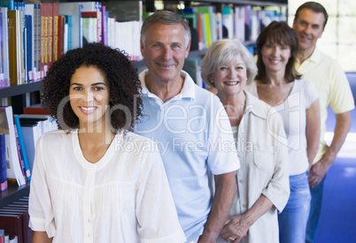 Adult students standing in a library