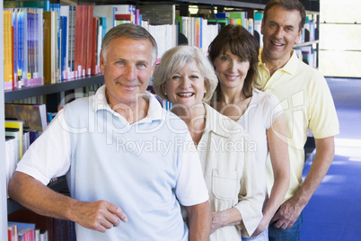 Adult students standing in a library