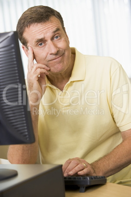 Confused man working on a computer