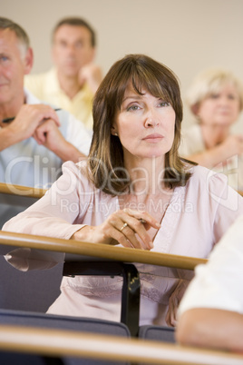 Female adult student listening to a university lecture