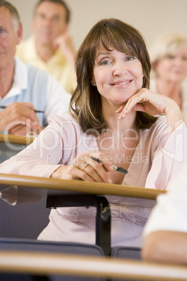 Female adult student listening to a university lecture