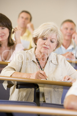 Senior woman listening to a university lecture