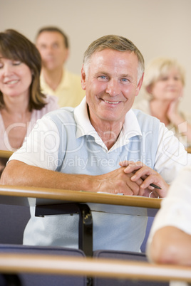 Senior man listening to a university lecture