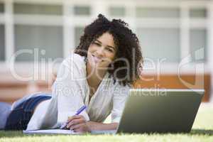 Woman using laptop on campus