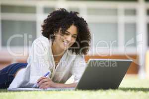 Woman using laptop on campus