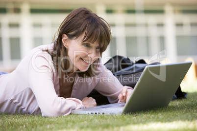 Woman using laptop on campus