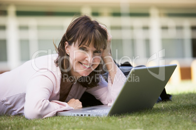 Woman using laptop on campus