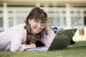 Woman using laptop on campus