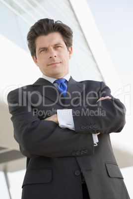 Businessman standing outdoors by building