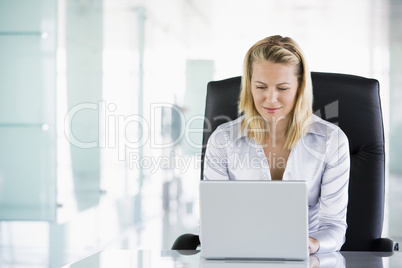 Businesswoman in office using laptop