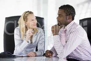 Two businesspeople in office talking