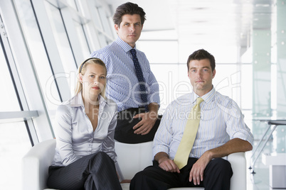 Three businesspeople sitting in office lobby