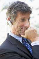 Businessman wearing headset outdoors