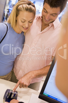 Couple making purchase in store